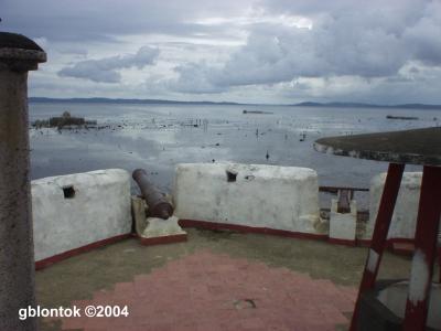 A view of the elevated deck with two of the three cannons. The well at the lower right is the vertical shaft leading to the tunnel.
Photo by:: GBLontok (2004)